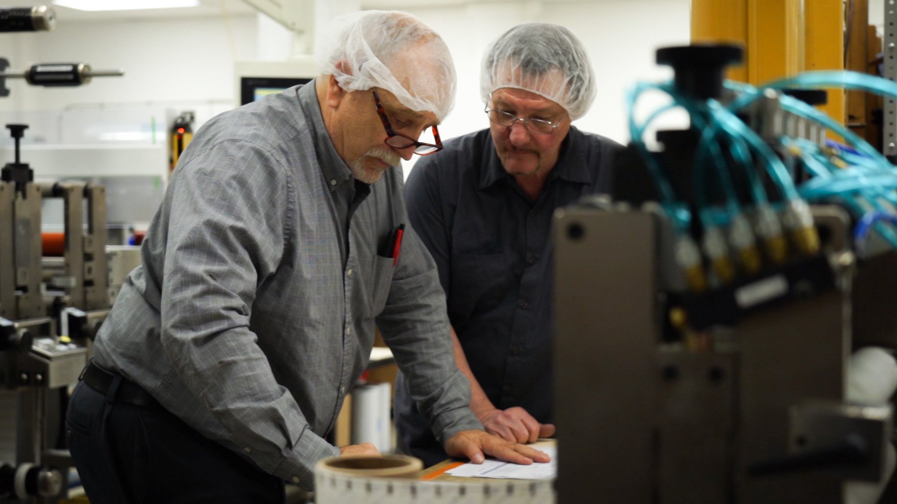 Manufacturing Employees Working at Desk